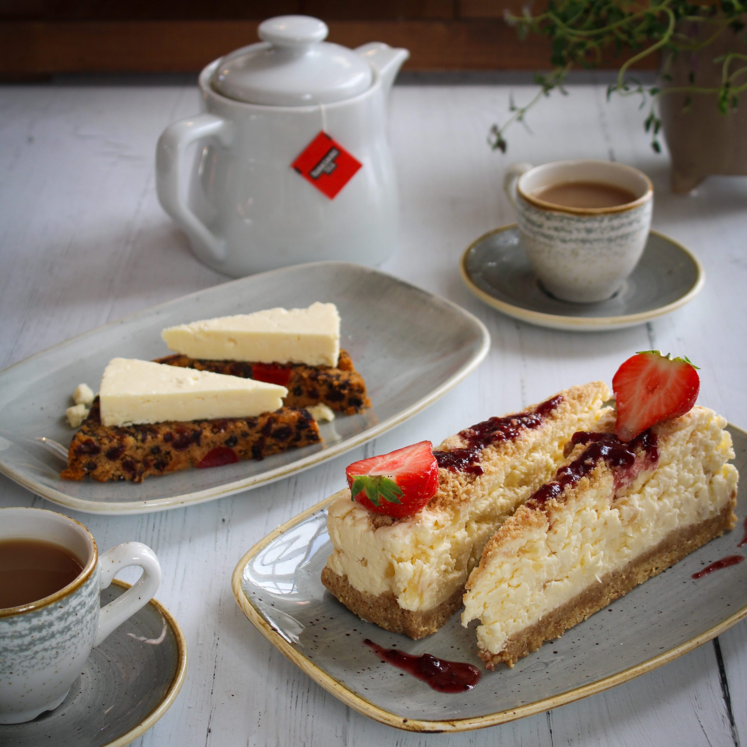 The sweet dishes in our Cheesy Afternoon Tea for Two: Yorkshire Wensleydale & Ginger Cheese Cheesecake and fruitcake with a slice of Wensleydale cheese
