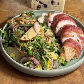 Bacon Wrapped Chicken Stuffed With Yorkshire Wensleydale & Cranberries, served with a side salad